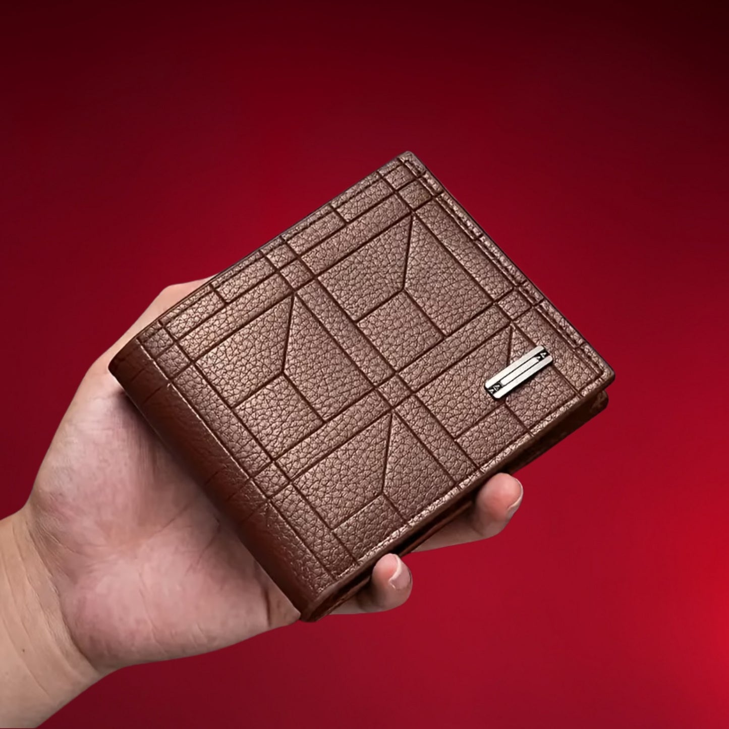 Brown leather wallet held in a hand against a red background