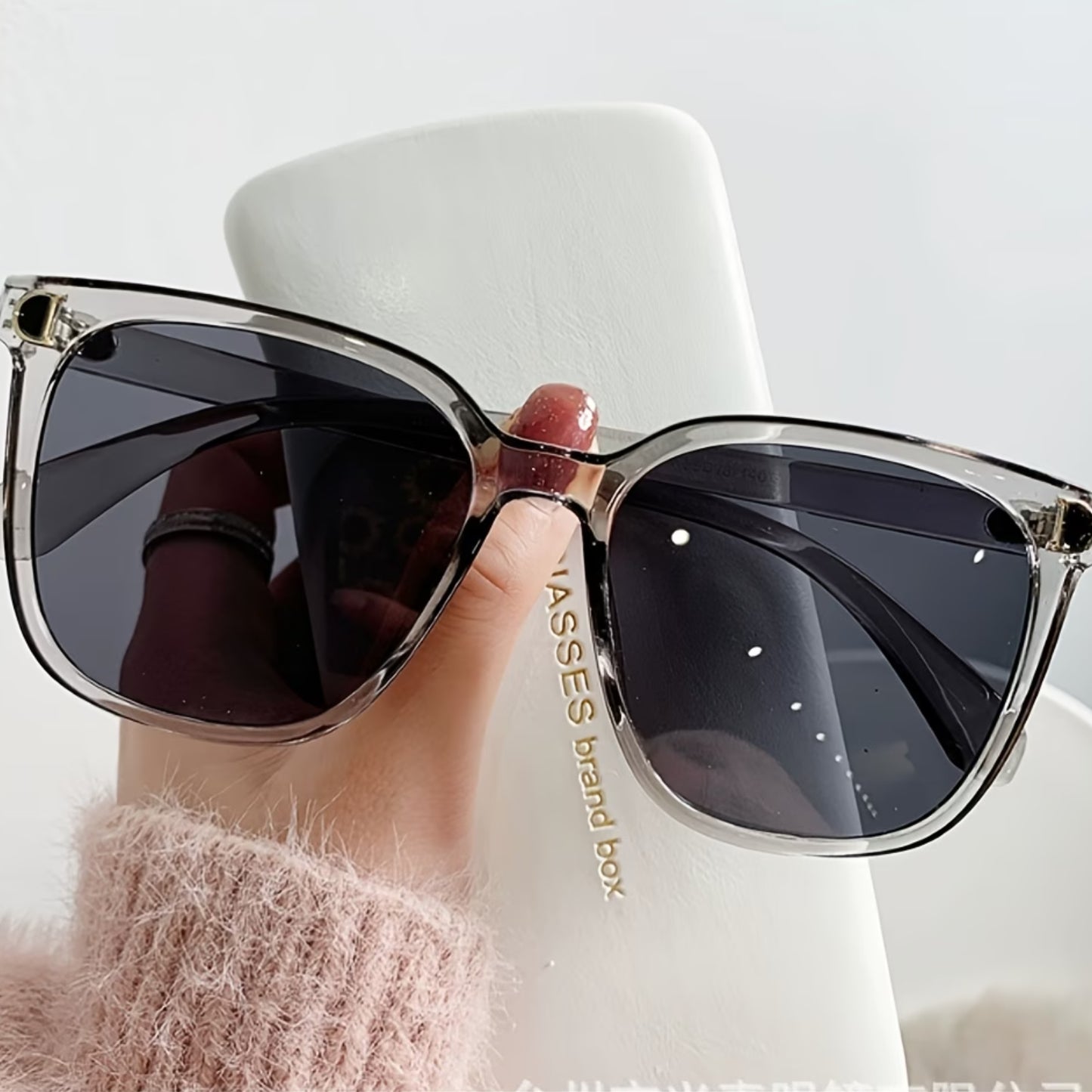 Front view of iconic oversized square sunglasses with a glossy black finish for a luxury fashion statement.